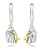 A little girl and a dog embrace earrings