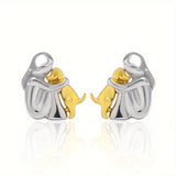 A little girl and a dog embrace earrings