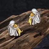 A little girl and a dog embrace earrings