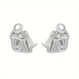 A little girl and a dog embrace earrings