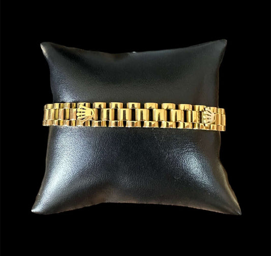 Pulsera RLX dorada acero inoxidable sobre almohadilla negra, tamaño 1 cm x 21 cm.