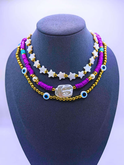 BNv0001 - Collar Plástico Bohemio Triple Morado Ojo Turco Calenbi Calenbi Joyería